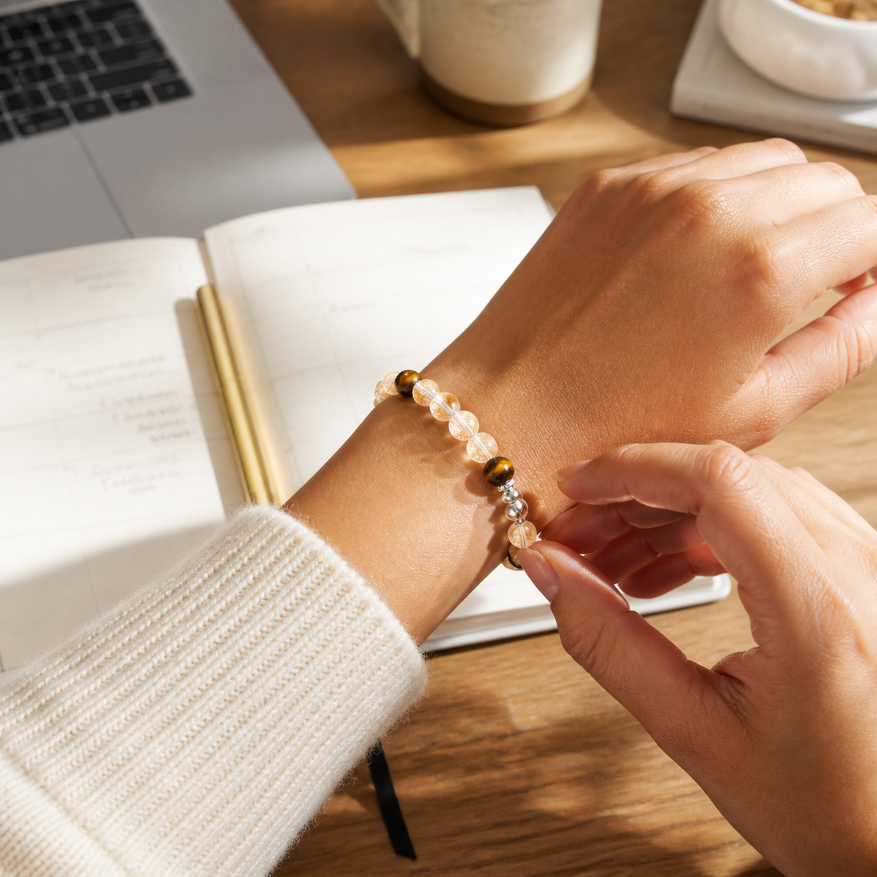 Golden Rutile Quartz and Tiger Eye bracelet worn at a planning desk