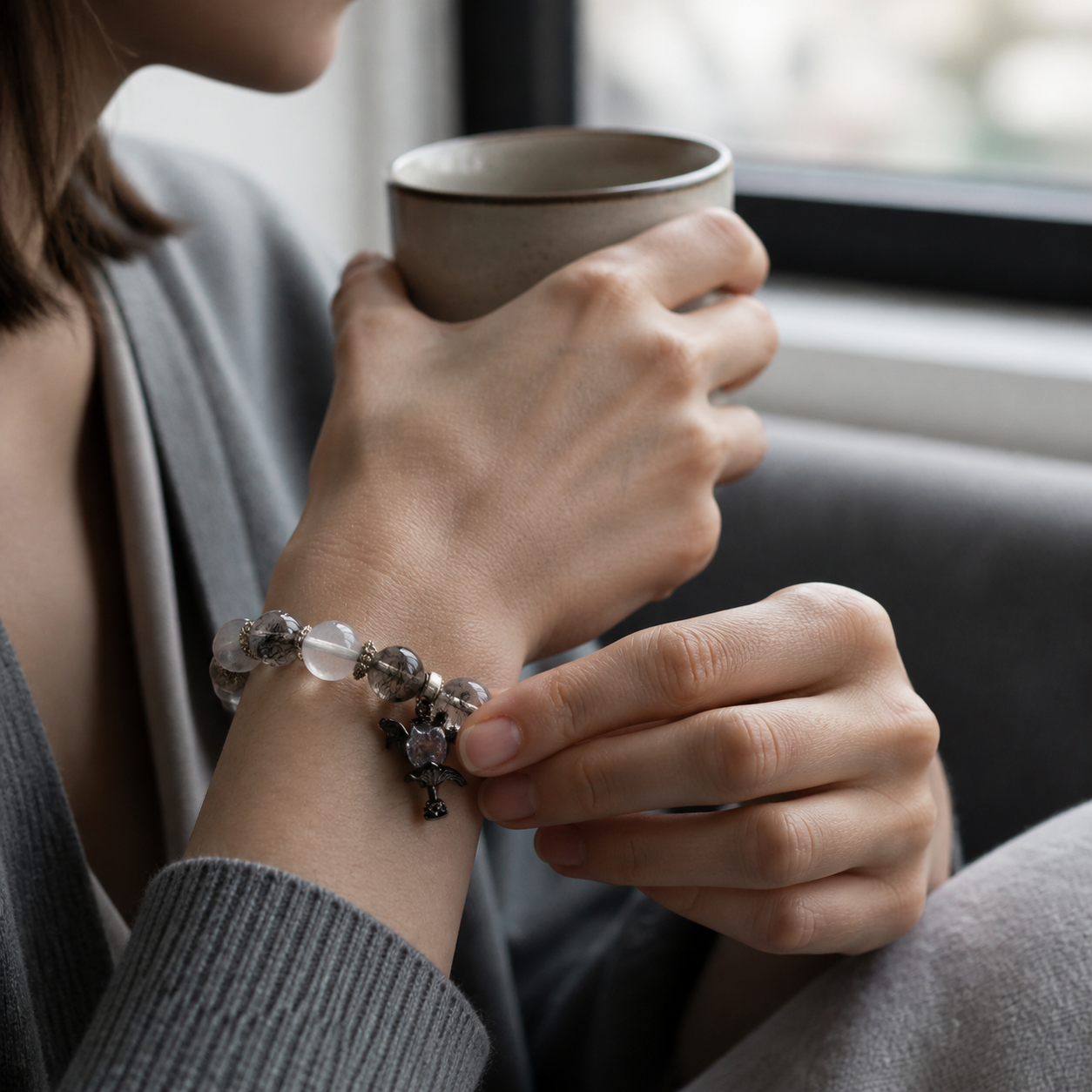 White Phantom Quartz Devil's Heart bracelet worn during a quiet reflection