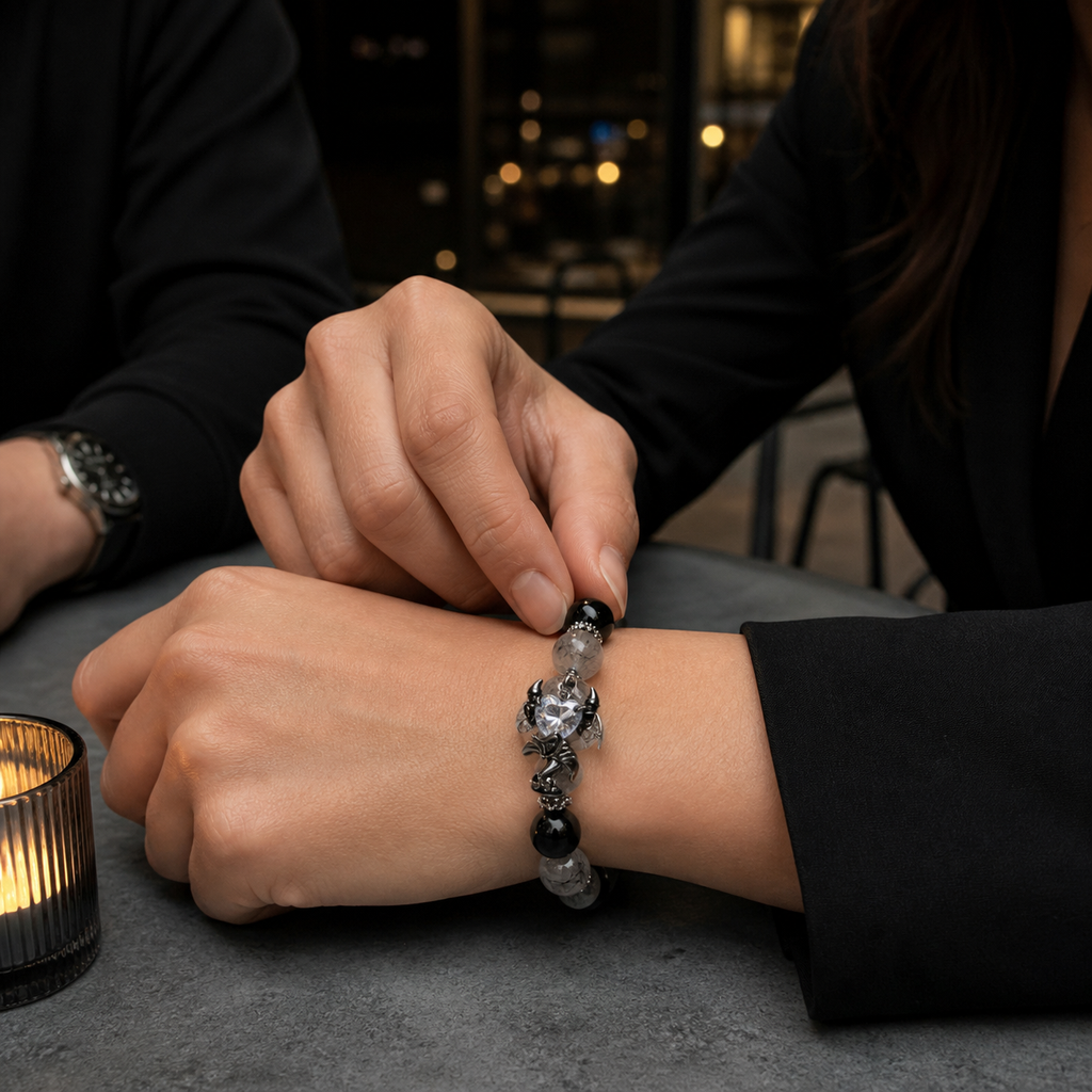 Obsidian Devil's Heart bracelet worn in a subtle shared moment