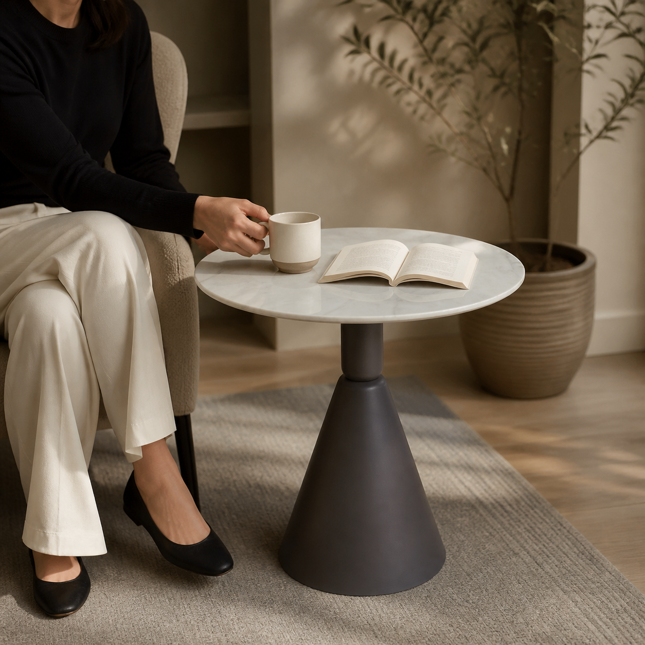 Round stone-look side table used in a quiet reading corner
